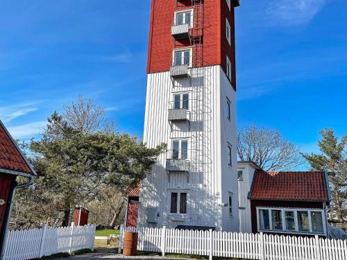 a tall white building with a red roof at 4 person holiday home in Drottningskär-By Traum in Drottningskär
