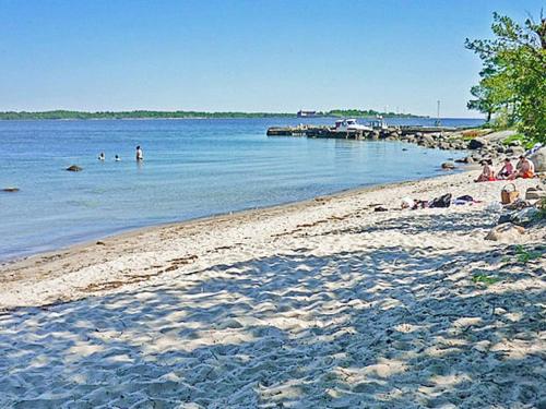 a group of people swimming in the water at a beach at 4 person holiday home in Drottningskär-By Traum in Drottningskär