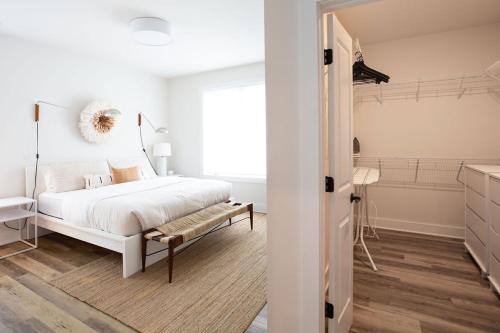 a white bedroom with a bed and a window at Piedmont Place Suite 301 - Near King Family Vineyards - Mtn Views in Crozet