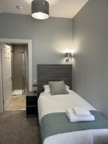 a bedroom with a bed with two towels on it at Arrandale Guest House in Edinburgh