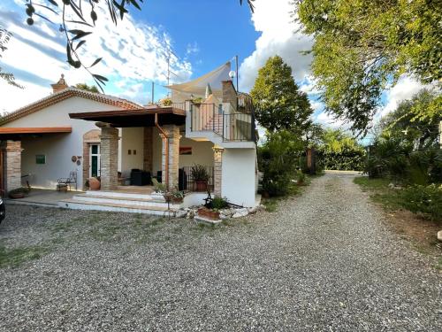 a white house with a gravel driveway at Villa Antonella in Pisticci