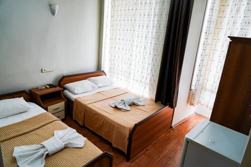 a hotel room with two beds and a window at Paradise Hotel in Istanbul