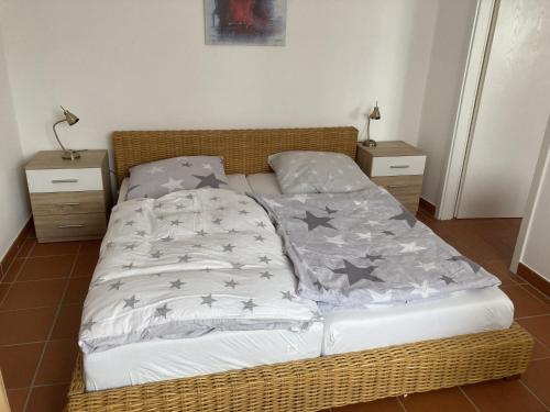 a bed in a room with two night stands and two tables at Oreste in Overath