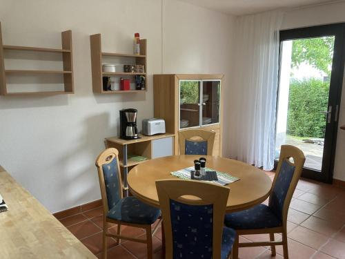 a dining room with a wooden table and chairs at Oreste in Overath