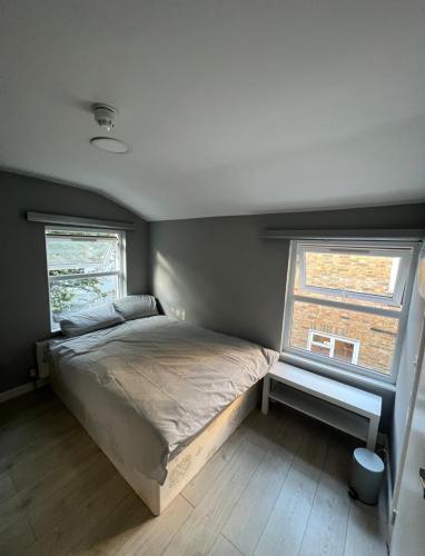 a bedroom with a bed and a window at Sterne Street in London
