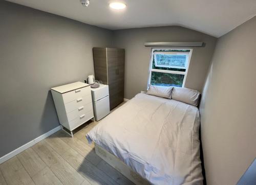 a small bedroom with a bed and a window at Sterne Street in London