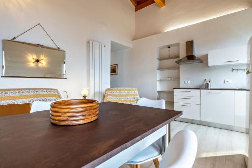 a kitchen and dining room with a table and chairs at Nonna Gina in Tignale