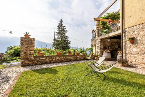 a patio with a chair in a yard at Nonna Gina in Tignale