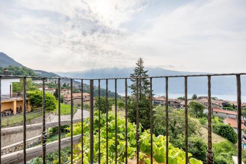 a view from the balcony of a house with mountains in the background at Nonna Gina in Tignale