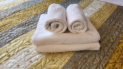 two towels sitting on top of a bed at Boutique Global in Braşov