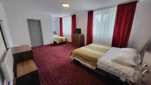 a hotel room with a bed and a window at Boutique Global in Braşov