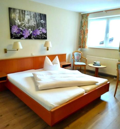 a hotel room with a bed and a window at Landhotel Vessens Hoff in Buchholz in der Nordheide