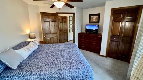 a bedroom with a bed and a flat screen tv at Baileys Harbor Yacht Club Resort in Baileys Harbor