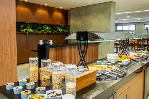a buffet of food on a counter in a kitchen at NH HOTEL FEIRA DE SANTANA in Feira de Santana
