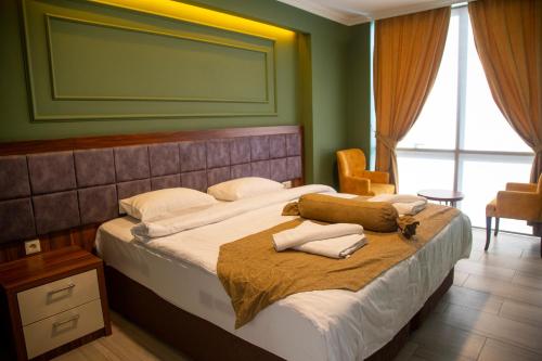 a bedroom with a bed with white pillows on it at TRABZON Asel Suite Otel in Trabzon
