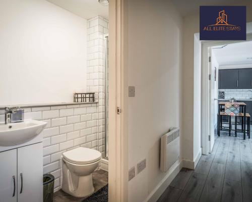 a white bathroom with a toilet and a sink at Swan House Apartment 7 - 2 Bed Apartment - Sleeps 5 - Free Parking - Liverpool - close to city centre - By ALL ELITE STAYS in Liverpool