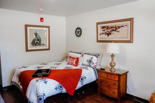 a bedroom with a bed and a dresser with a lamp at Beautiful Beginnings at Bayside in Crystal River