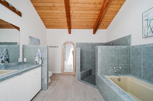 y baño con bañera y lavamanos. en @ Marbella Lane - 3BR Charming Hillside Retreat, en Moraga