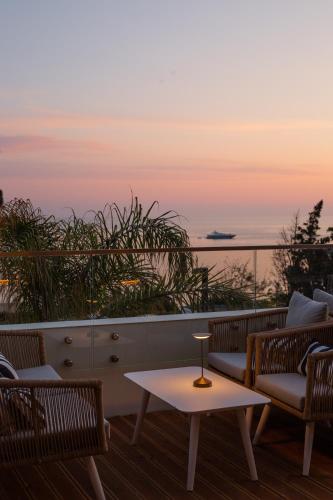 a table and chairs on a balcony with a view of the ocean at White Hill Hotel, SPA & Conferences in Durrës