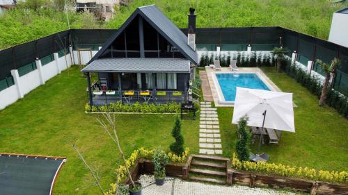 an aerial view of a house with a pool and an umbrella at Mono house kartepe in Kocaeli