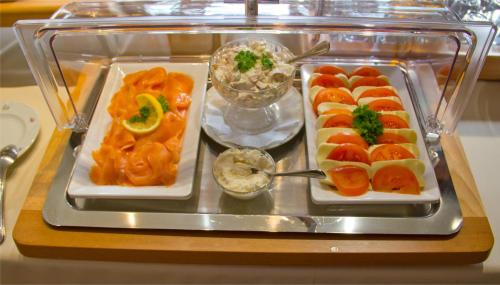 a tray filled with different types of food on a table at Hotel Kreuzer in Wedel