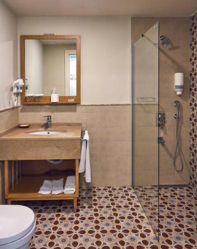 a bathroom with a sink and a shower at Meydani Otel in Gokceada Town