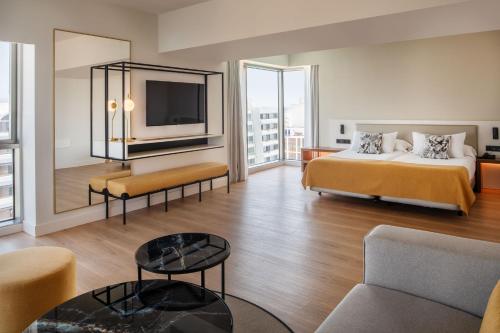 a hotel room with a bed and a tv at Arrecife Gran Hotel & Spa in Arrecife