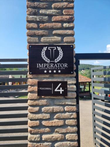 a sign on the side of a stone pillar at Imperator Kvintil apartmani & SPA in Ležimir