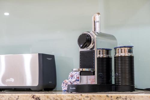 a microwave and a television on a table at Parrearra Paradise On The Water With Water Slide in Parrearra