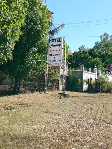 a sign for a hotelasy sign in a field at SUNNY HOTEL MAHAJANGA in Mahajanga