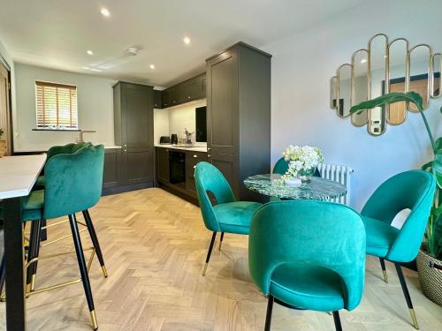 a dining room with blue chairs and a table at 4 The Nest Central Ripon in Ripon
