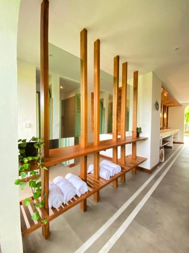 a row of mirrors in a bathroom with towels at White Penny Hostel in Seminyak