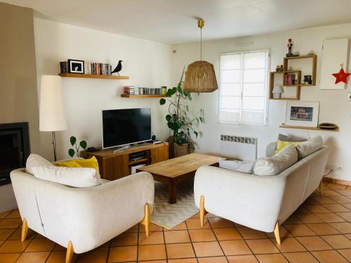 a living room with two couches and a table at Villa avec piscine à Fuveau in Fuveau