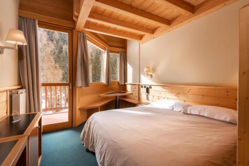 Postel nebo postele na pokoji v ubytování Hotel Garni Pegrà