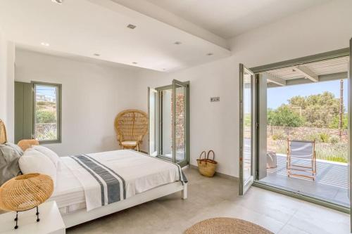 a bedroom with a bed and a balcony at Villa Xifara - Seafront in Santa Maria