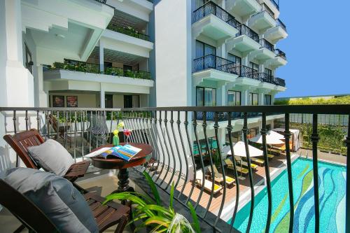 a balcony of a building with a swimming pool at Silkian Hoian Boutique Hotel & Spa in Hoi An
