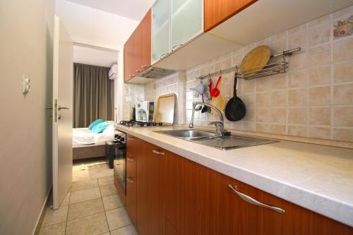 a kitchen with a sink and a counter top at Apartment Rajka 2277 in Premantura