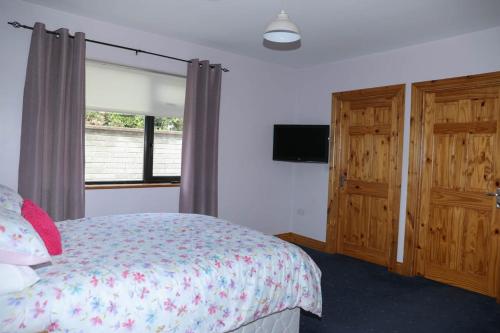 a bedroom with a bed and a window at Narrow water house in Dundalk