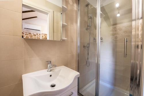 a bathroom with a sink and a shower at Kuća za odmor Nikola in Zadar