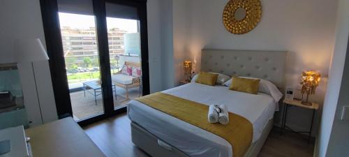 sypialnia z dużym łóżkiem i balkonem w obiekcie Teatinos Suite w Maladze
