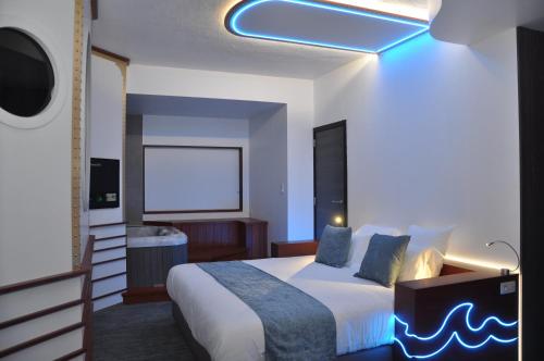 a bedroom with a bed with a blue light on it at Inthemia in Tournai