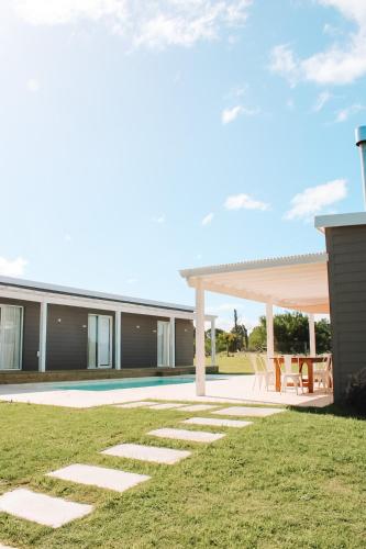 a house with a swimming pool and a patio at Casa de mar - José Ignacio in José Ignacio