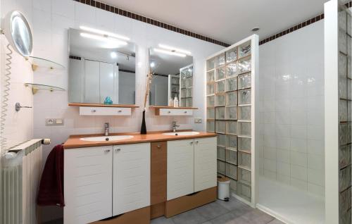 a bathroom with two sinks and a shower at Lovely Home In Vias With Outdoor Swimming Pool in Vias