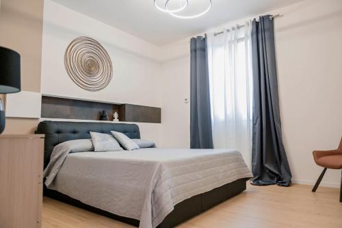 a bedroom with a large bed with a blue headboard at HABITAT- Apartments&Rooms in Cerignola