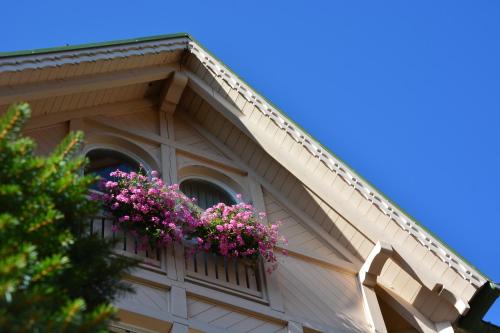 a balcony with pink flowers on a building at Hotel Pangrazzi - 3 stelle superior in Fucine