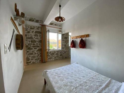 a bedroom with a bed and a window at Asterion Bella View in Zaros