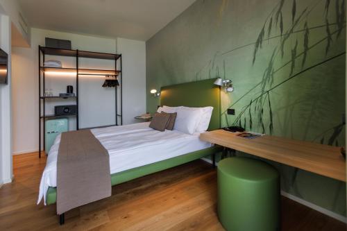 a bedroom with a bed and a wooden table at Hotel Meridiana in Malcesine
