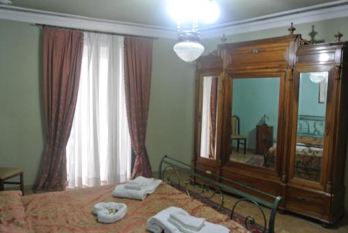 a bedroom with a bed and a large mirror at Locanda degli Illustri in Civitanova del Sannio