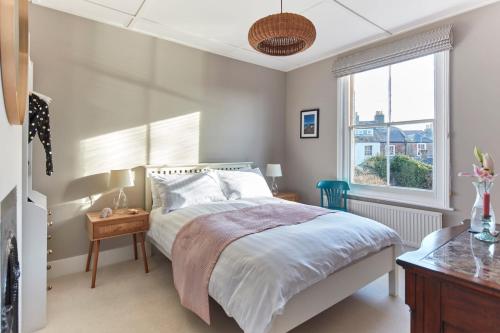 a bedroom with a bed and a window at Cosy retreat, perfectly located just a min walk from Deal Beach and Castle in Deal