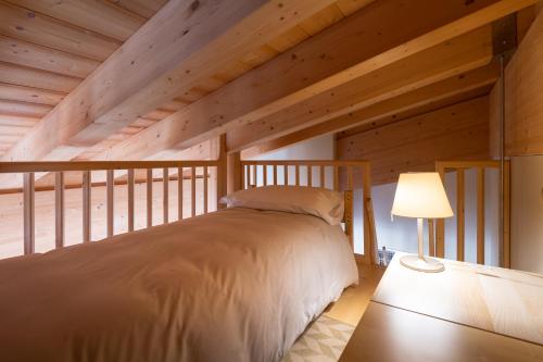 a bedroom in a log cabin with a bed at Hotel Garni Pegrà in Ponte di Legno